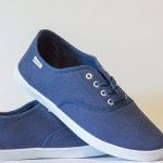 Pair of stylish blue canvas shoes with white soles displayed against a neutral background.